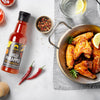 SIAM Chilli pineapple sauce bottle with wings and ingredients on a table